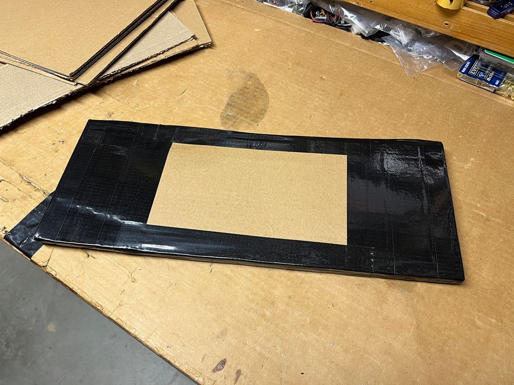 Four layers of cardboard, 18" x 7", did the trick.  Oh, I needed the black duct tape too.