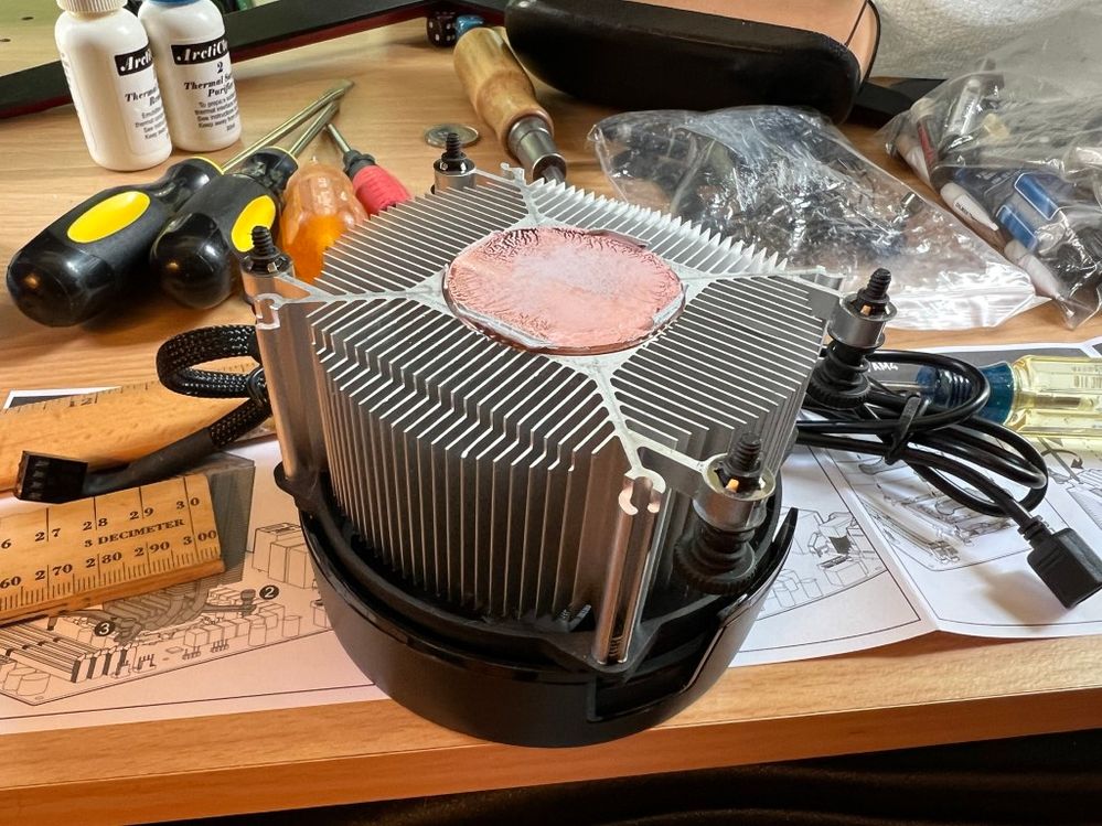 Removing the stock AMD CPU cooler; note the good thermal paste coverage.