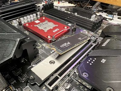 Installing an AMD Ryzen 7700X CPU with a 'socket frame' to better support the CPU cooler.