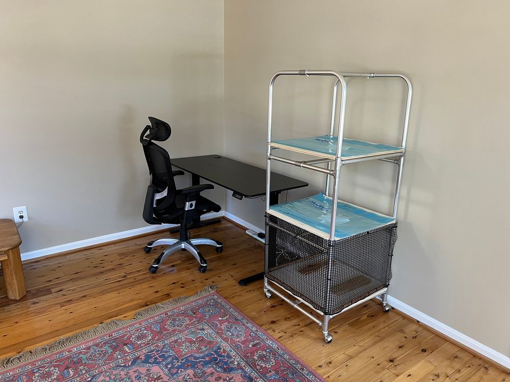 Ok, the floor has been cleaned and I moved my computer desk and chair into the corner.  I brought up the plant rack (minus the computer) to see how it looks.