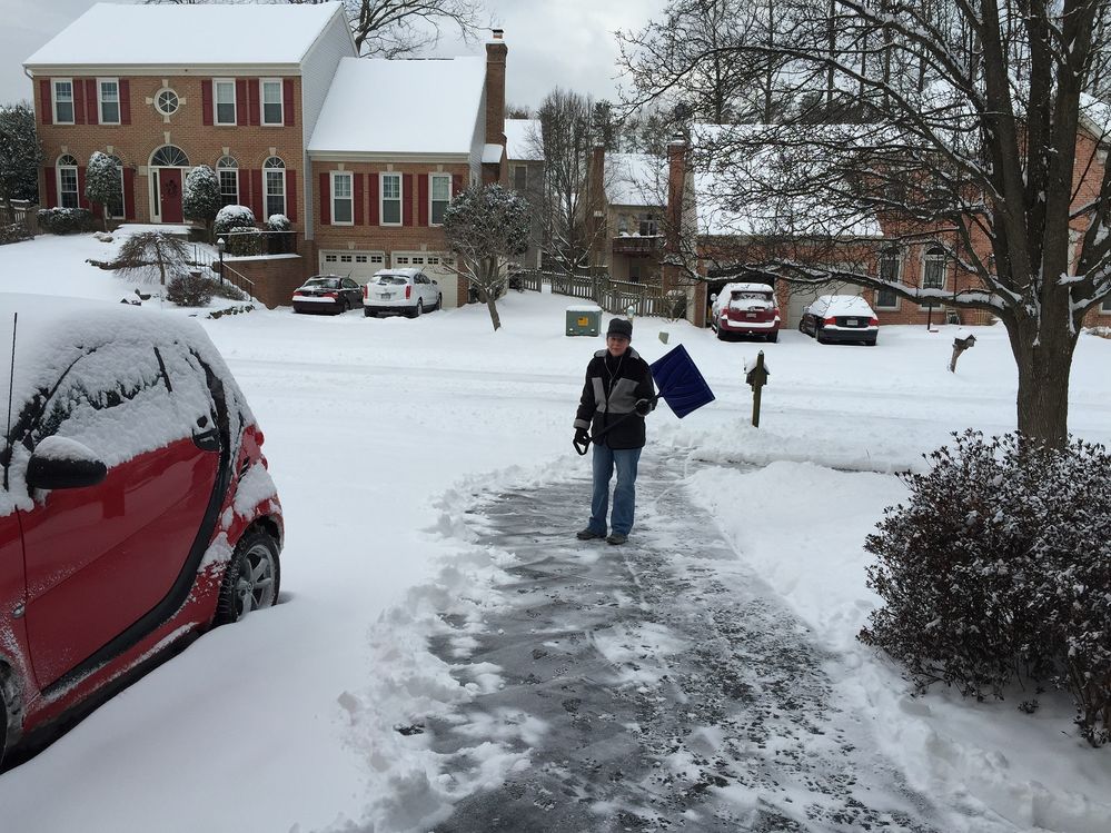 Sandra shoveling our driveway in 2015.