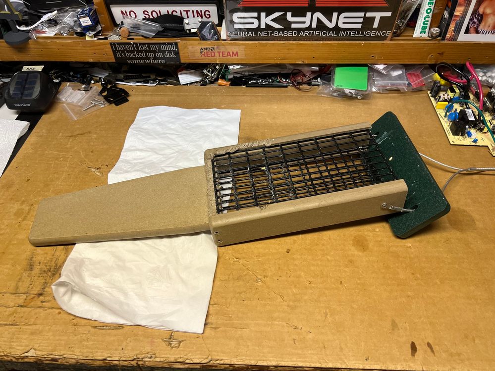 Squirrel damaged suet feeder made of composite plastic.