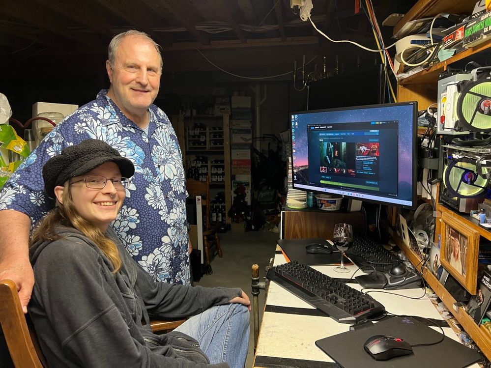 Our daughter with Dutch-Uncle Greg at the workbench playing Stray.